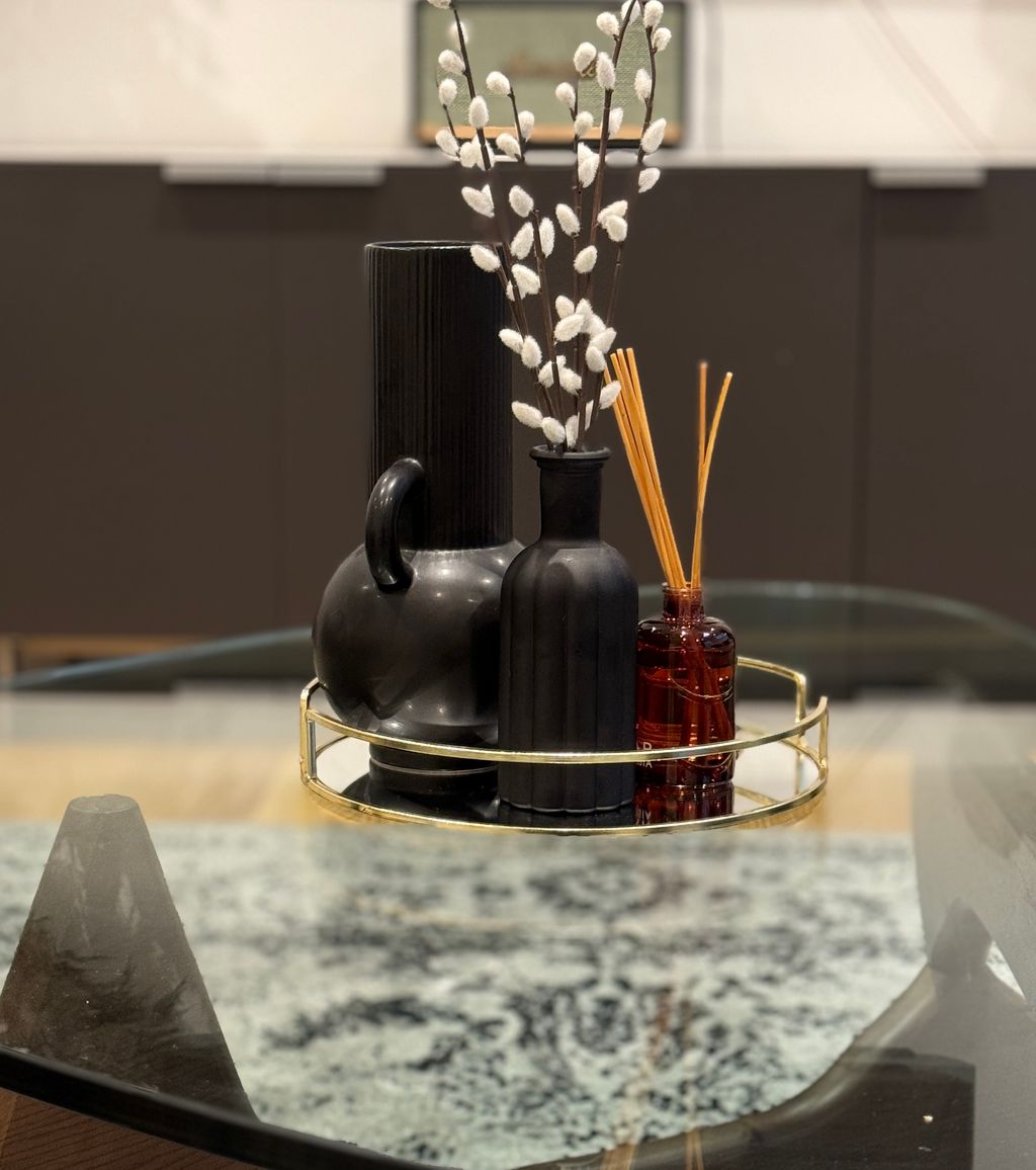 a collection of fragrance sticks on a glass table